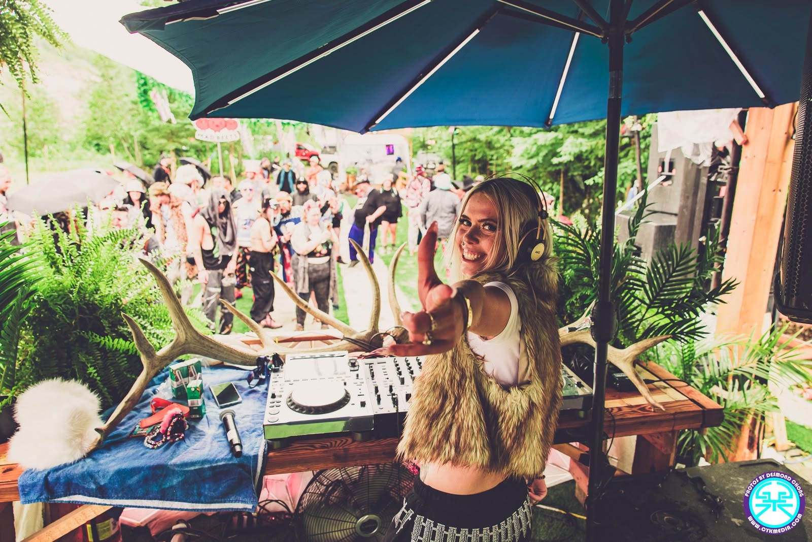 ROZENZA smiling at the camera while DJing a daytime outdoor festival set